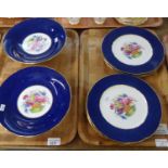 Six Copeland Spode dinner plates with blue and gilt rims and central rose, lilac and tulip floral