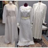 Three vintage full length long sleeve wedding dresses to include: a cream long sleeve