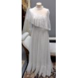 Vintage 1970's lace wedding dress with tiered skirt, sheer sleeves and one shoulder ruffle. (B.P.