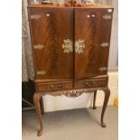 Reproduction mahogany two door blind panelled cocktail cabinet on cabriole legs. (B.P. 21% + VAT)