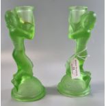 Pair of Art Deco uranium green moulded glass candle sticks decorated with female figures on a