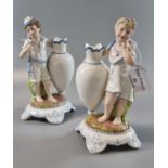 Pair of continental porcelain figural spill vases of water carriers on naturalistic base. Height