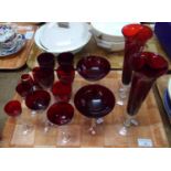 Tray of cranberry glass items, mostly Czech drinking glasses with clear twisted stems; champagne,