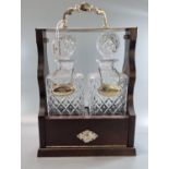 Reproduction mahogany finish and glass two section tantalus with Gin and Whisky silver plated