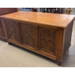 20th century oak blanket box/chest with hinged lid above three carved panels. 109x48x55cm approx. (