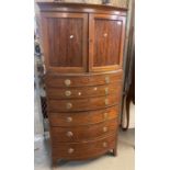 19th century mahogany bow fronted cabinet chest, the two blind panelled doors above a bank of six