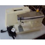 Vintage electrical Singer sewing machine in travel case. (B.P. 21% + VAT)