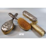 Two Art Nouveau silver vanity dressing table brushes, together with two other similar hair brushes