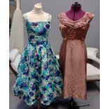 Two 50's/60's vintage evening dresses; one is a floral printed ball gown type dress with built in