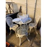 Modern metal and pierced garden table of circular form with six matching garden chairs. (B.P.