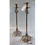 Pair of decorative polished steel Art Nouveau design candle sticks with pierced decoration 36cm high