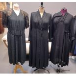 Three vintage 20's-40's black dresses: one in black crepe with lace short sleeves and shoulders