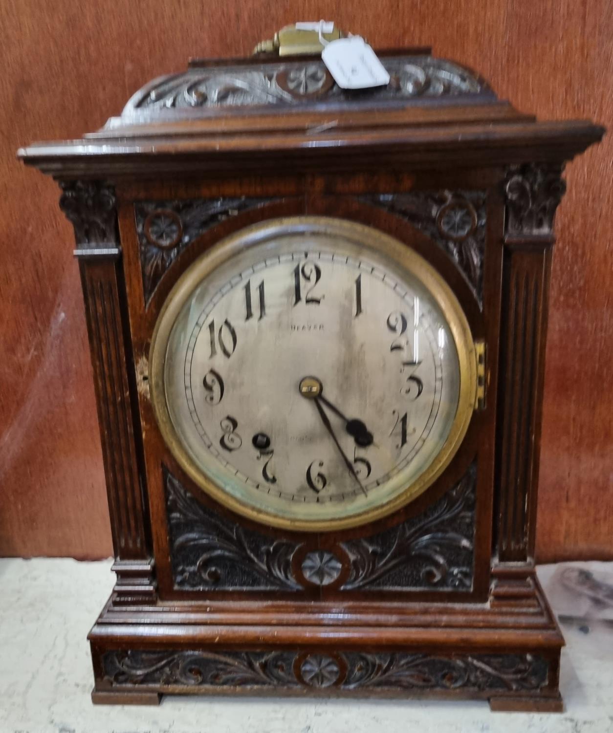 Late 19th/early 20th century ornately carved walnut two train bracket clock with key and pendulum