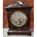 Late 19th/early 20th century ornately carved walnut two train bracket clock with key and pendulum