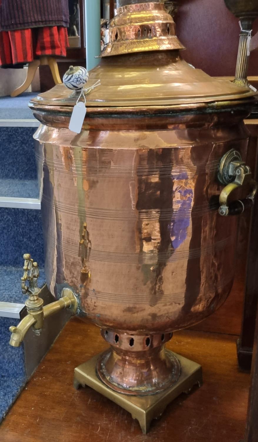 Large Victorian copper and brass lidded samovar with ceramic blue and white handles and brass tap.