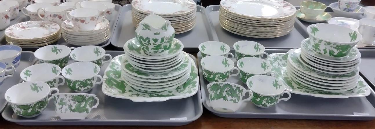 Two trays of Coalport green dragon design tea and dinnerware to include: teacups and saucers,