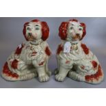 Pair of Staffordshire style fireside spaniels with painted features and open cast feet. Modern. (