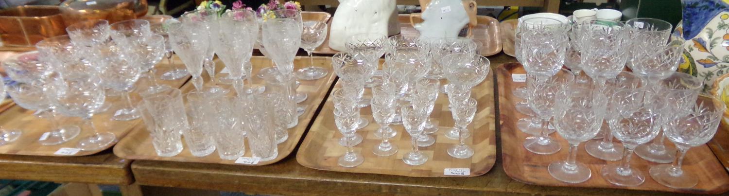 Four trays of assorted cut glass drinking glasses: six etched and cut glass hock glasses, various