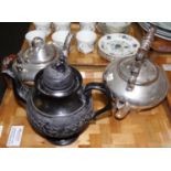 Three teapots: one black basalt teapot with girl knop and pedestal base and two silvered ceramic