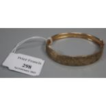 9ct gold engraved bangle. 9.4g approx. (B.P. 21% + VAT)