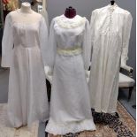 Three vintage full length long sleeve wedding dresses to include: a cream long sleeve
