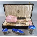 Collection of pink and blue enamel and silver vanity items, to include: hand mirror, brushes,