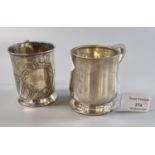 Two early 20th century silver christening mugs, one dated 24-2-29, the other with repoussé floral