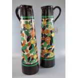 Pair of Bishop England large tapering single handled jugs, printed and hand painted enamelled