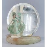 Art Deco design unframed bevelled circular mirror with china figurine of a lady in bonnet and