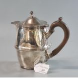 Early 20th century silver single handled hot water jug with turned wooden handle, Birmingham