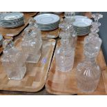 Two trays of glass decanters to include: three matching with star cut bases, various cut and moulded