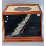 Modern cased diorama of 'The sinking of the Titanic', the top with a painted porthole and the