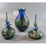 Collection of modern Okra art glass on a blue ground, decorated with flowers and foliage, to