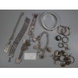 Collection of silver and white metal jewellery: charms, bangle, dress rings etc. (B.P. 21% + VAT)