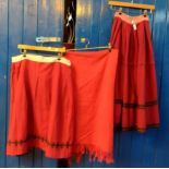 Two traditional woollen antique late 19th Century Welsh costume skirts, both red with stripes but