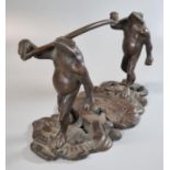 Art Nouveau style bronze figure group of two striding frogs carrying a log or a stick on