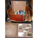 Box containing wooden cribbage board, two photograph albums with black and white photographs, one