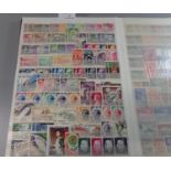 Large blue stockbook of stamps with good range of countries including: Estonia, Latvia, Iraq,