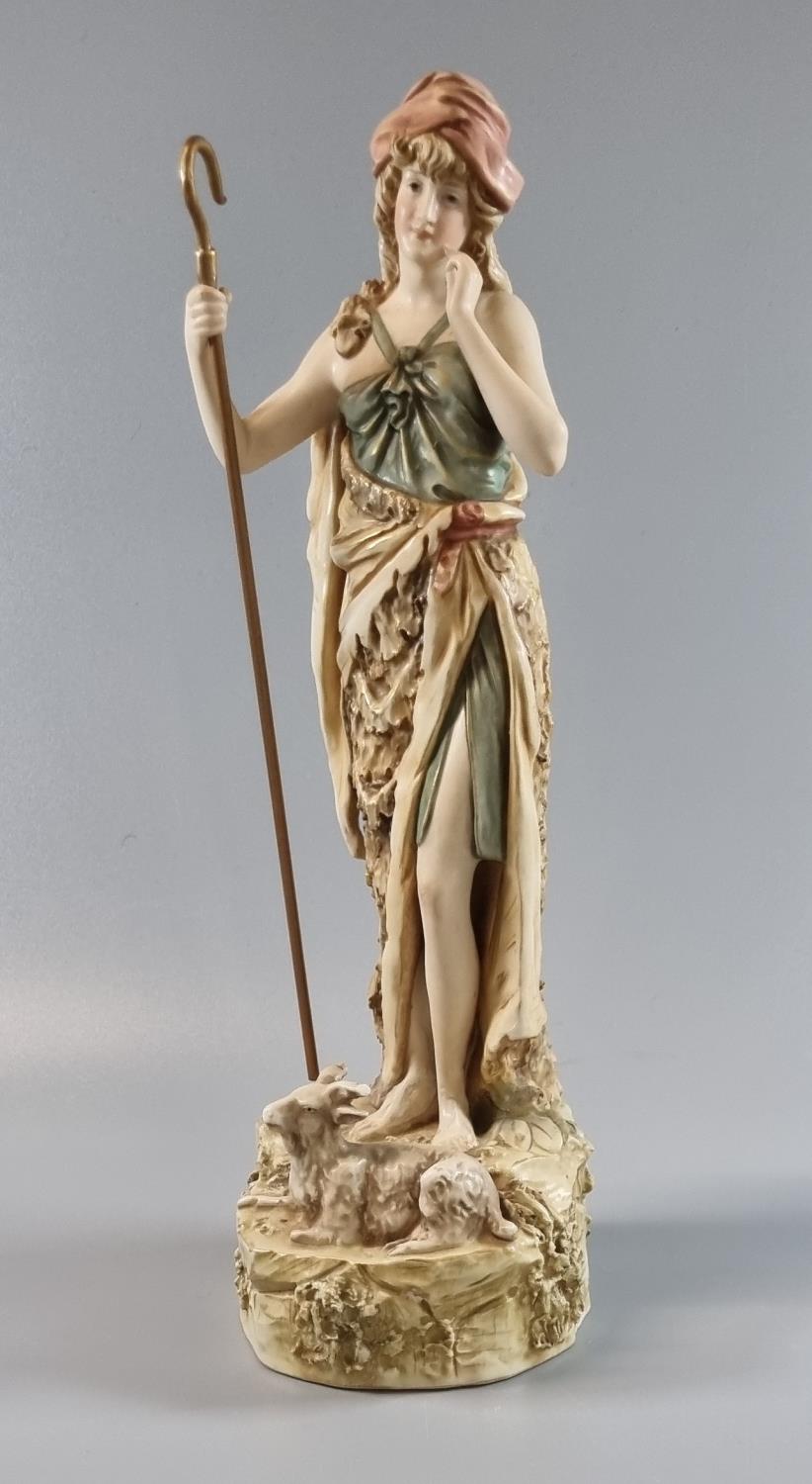 Royal Dux porcelain 352 figure of a shepherdess with lamb at her feet on a naturalistic base, 30cm