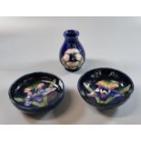 Two similar Moorcroft art pottery tube lined orchid design bowls. 12 & 11cm diameter approx.