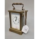 Early 20th century brass carriage clock with enamel face and Roman numerals, with key. (B.P. 21% +