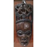 African tribal hardwood mask, the headdress carved with two figurines. 68cm high approx. (B.P. 21% +
