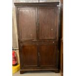 Early 20th century stained pine larder type cupboard of narrow proportions having four blind