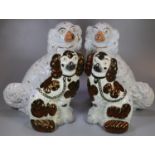 Two pairs of Staffordshire fireside seated spaniels with painted features; one in lustre design. (4)