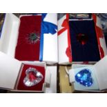 Two trays of Swarovski crystal ornaments and decorations in original boxes: crystal hearts,