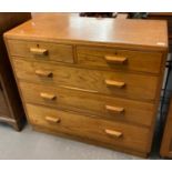 Mid Century pale oak utility straight front chest of two short and three long drawers with geometric