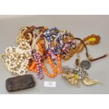 Large collection of costume jewellery items, including: bead necklaces, brooches, small purse