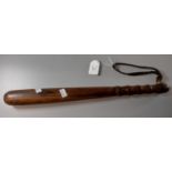 Turned hardwood truncheon with leather wrist strap. (B.P. 21% + VAT)