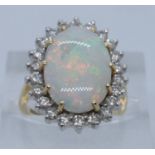 18ct gold opal and diamond dress ring. Size H + 1/2, 5.8g approx. Cased. (B.P. 21% + VAT)