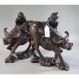 Two Chinese hardwood carvings of boys on buffalo, standing on a naturalistic base. (2) (B.P. 21% +